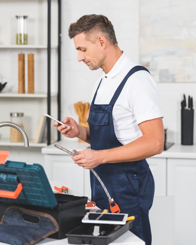 Service professional reviewing work on smartphone during a job